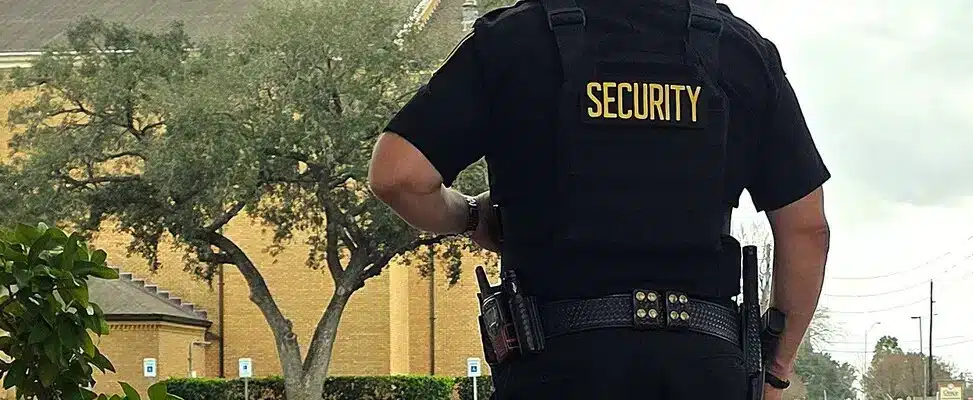 armed-security-guard-kansas-img-1 Security guard standing outside building