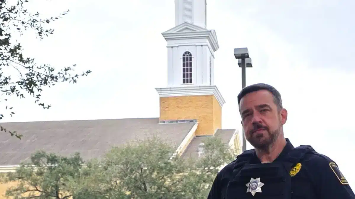 residential-security-services-kansas-img-1 Police officer standing in front of church steeple
